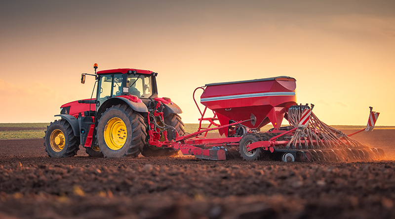 Farmer in tractor preparing farmland with seedbed for the next year