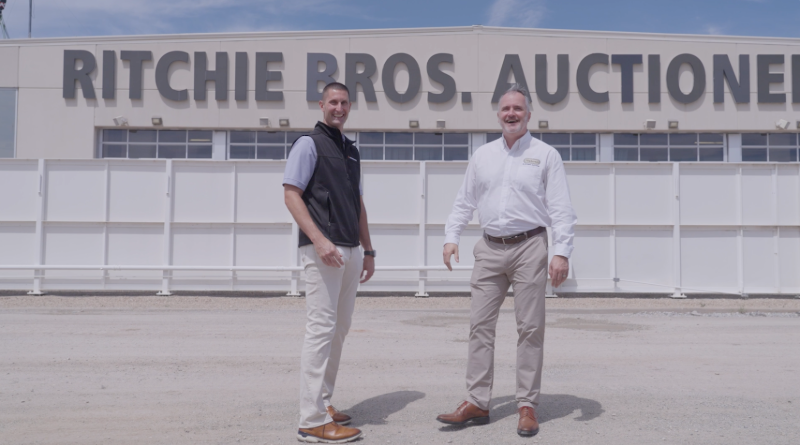 Casey Fencl and Thomas Blackmon stand together at a Ritchie Bros. yard.